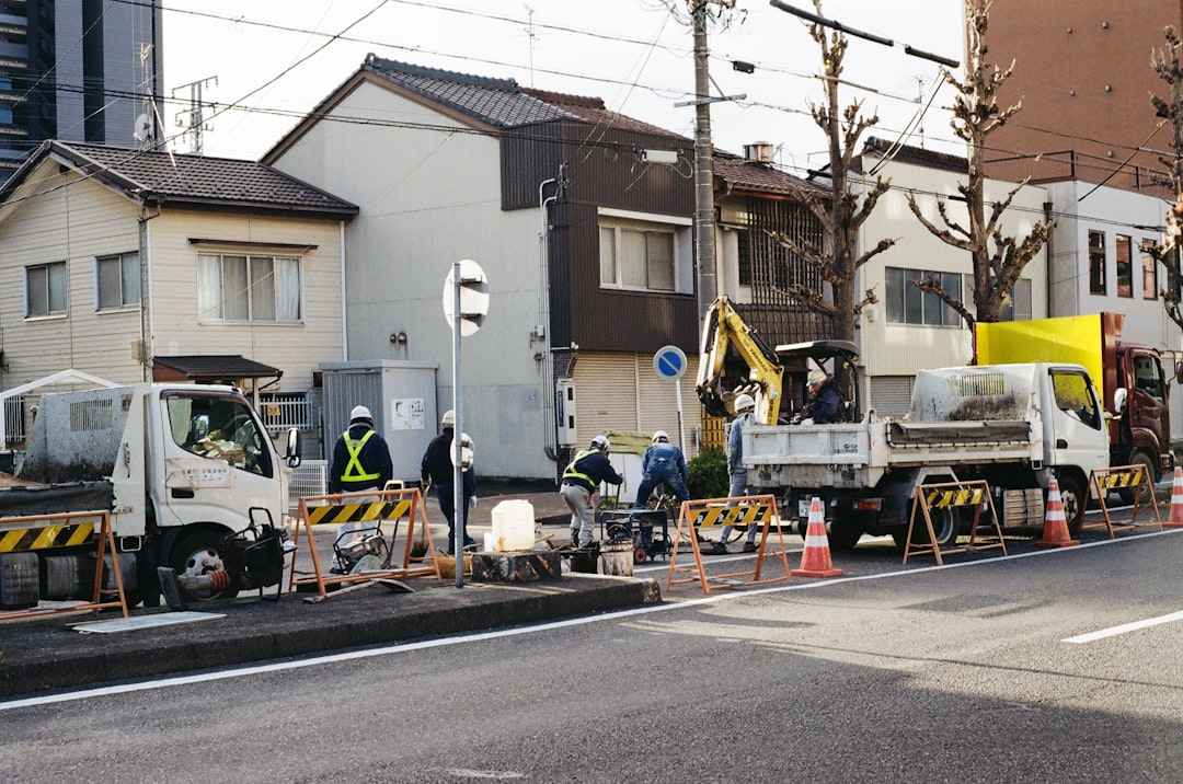 construction-workers-on-a-city-street-with-vehicles-fh1yv1sdeai