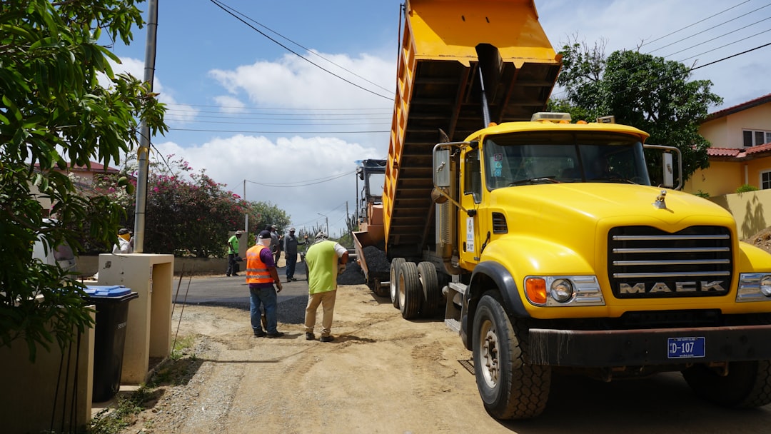 yellow-dump-truck-unloading-dirt-onto-a-street-5eiosdjnle4